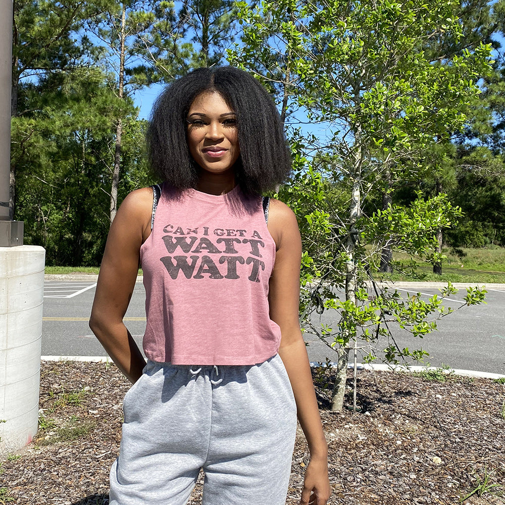 Woman wearing a heather mauve crop top that says "Can I get a watt watt?" from The Movement Shop