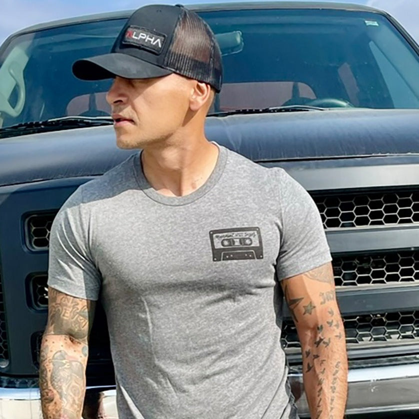 Man wearing a deep heather unisex t-shirt that says "Movement comes in all sizes"