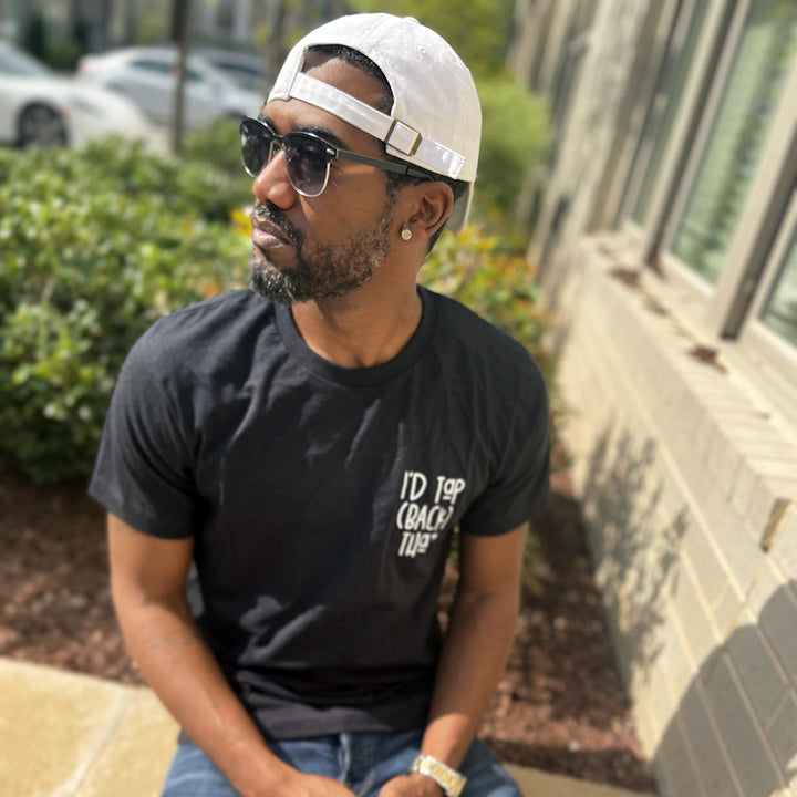 Man wearing a unisex heather black shirt from The Movement Shop that says "I'd Tap (Back) That"