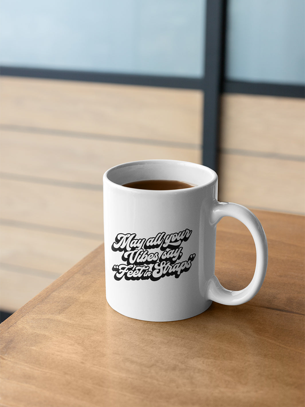 11oz white coffee mug that says "May all your vibes say Feet In Straps" in retro black font