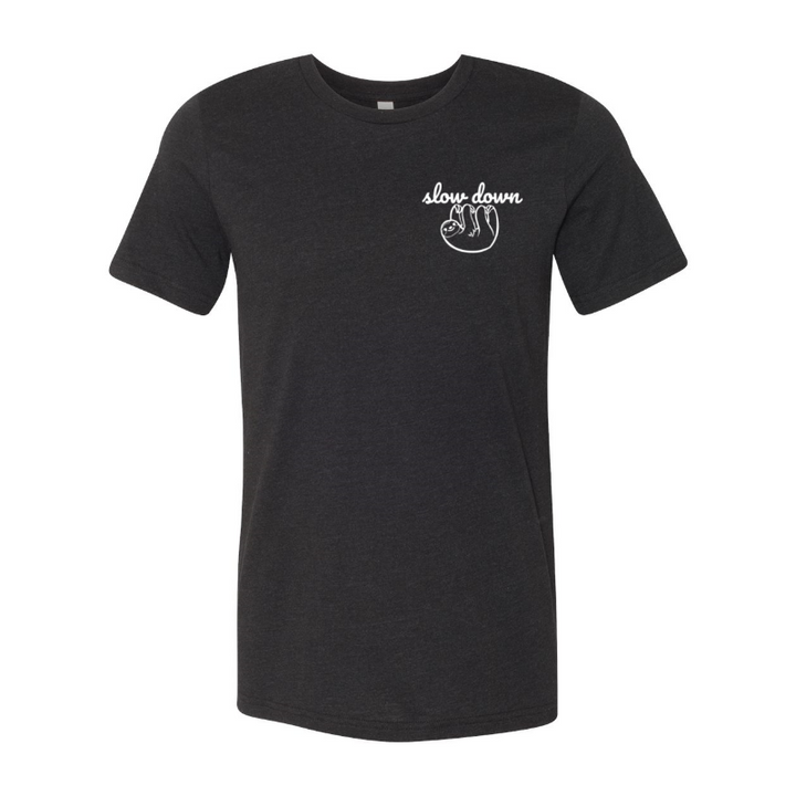 Heather Black Unisex Crewneck T-Shirt that has the text "slow down" in white script over a white sloth on her left chest logo.