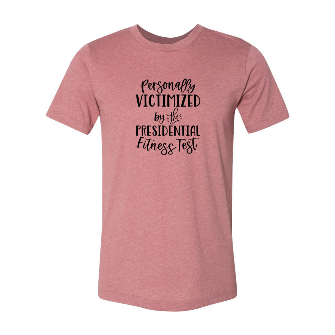 A mauve unisex crewneck t-shirt that says "Personally Victimized by the president fitness test"