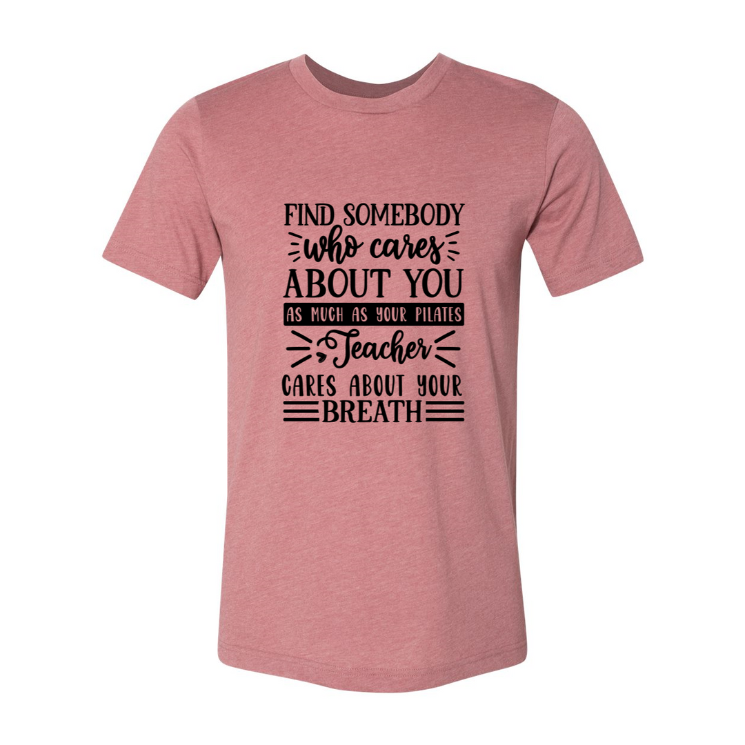 Woman wearing a unisex crewneck heather mauve t-shirt that says "Find Somebody Who Cares About You As Much As Your Pilates Teacher Cares About Your Breath"