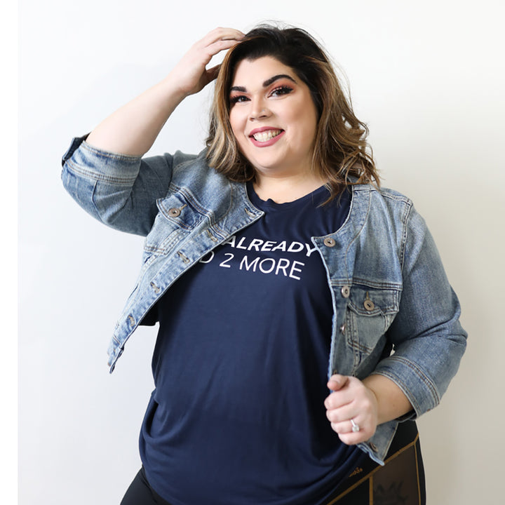 Woman wearing a blue muscle tank top that says "You Already Said Two More" In white text