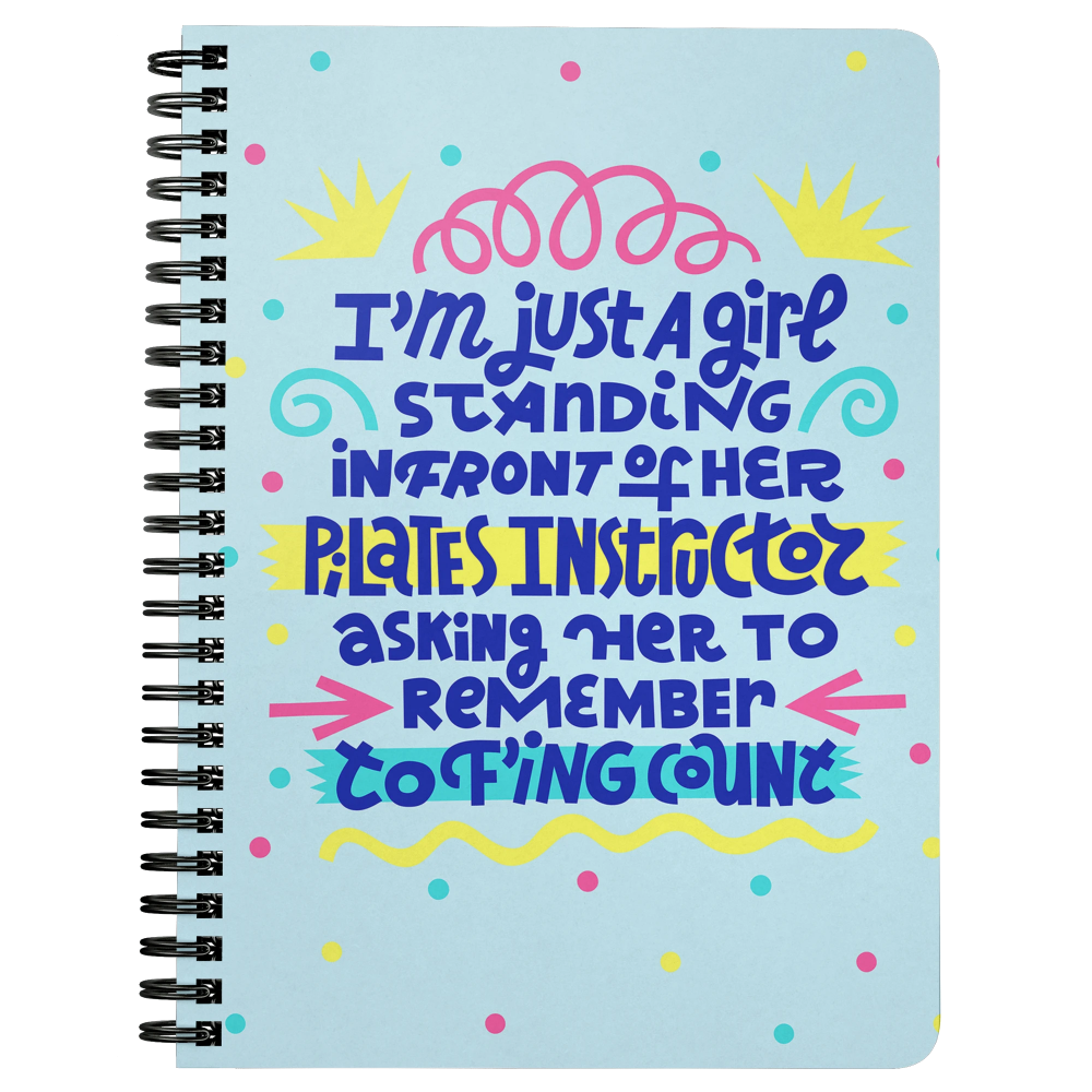 Spiral bound blue notebook that says "I'm just a girl standing in front of her pilates instructor asking her to remember to f'ing count"
