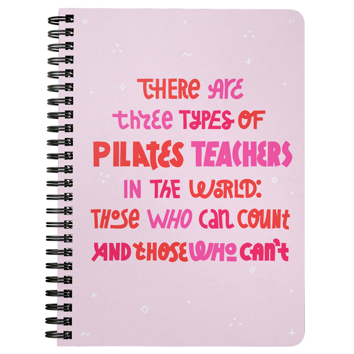 Pink spiral bound notebook that says 'there are three types of pilates teachers in the world: those who can count and those who can't