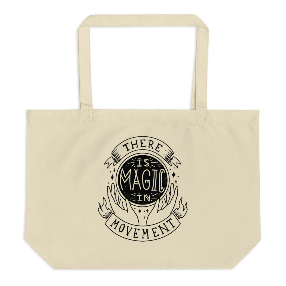 Canvas tote with handles that says "There is Magic In Movement" in black text. It is designed to look like crystal ball.