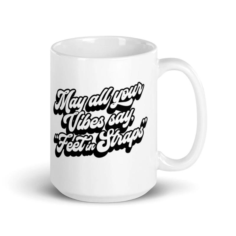 15oz white coffee mug that says "May all your vibes say Feet In Straps" in retro black font