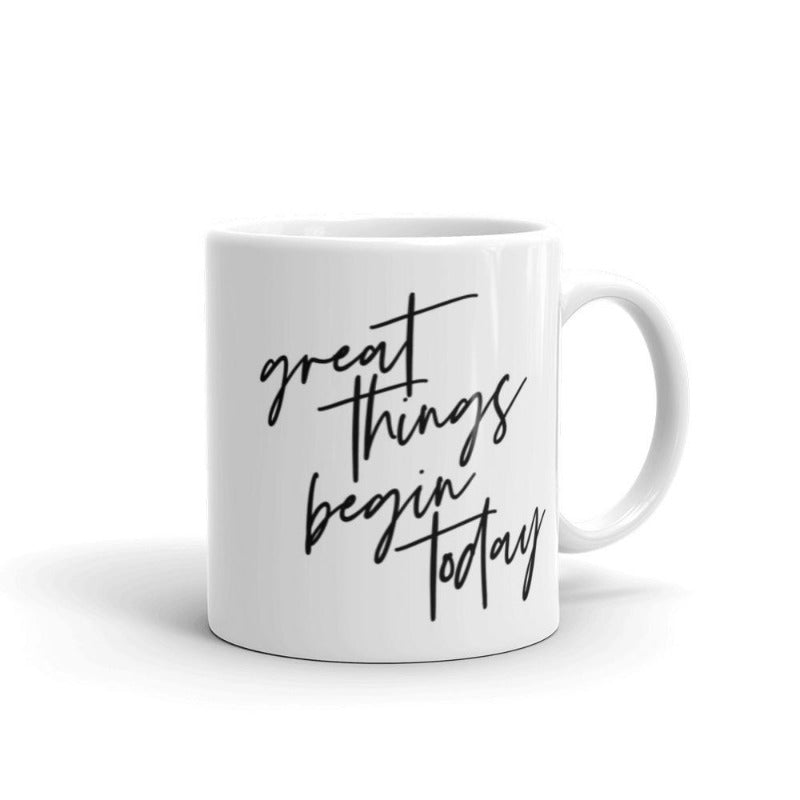 White 11 oz coffee mug that says "Great things begin today" in black text. The quote is a nod to the Joseph Pilates Quote, "every moment of our lives can be the beginning of great things"