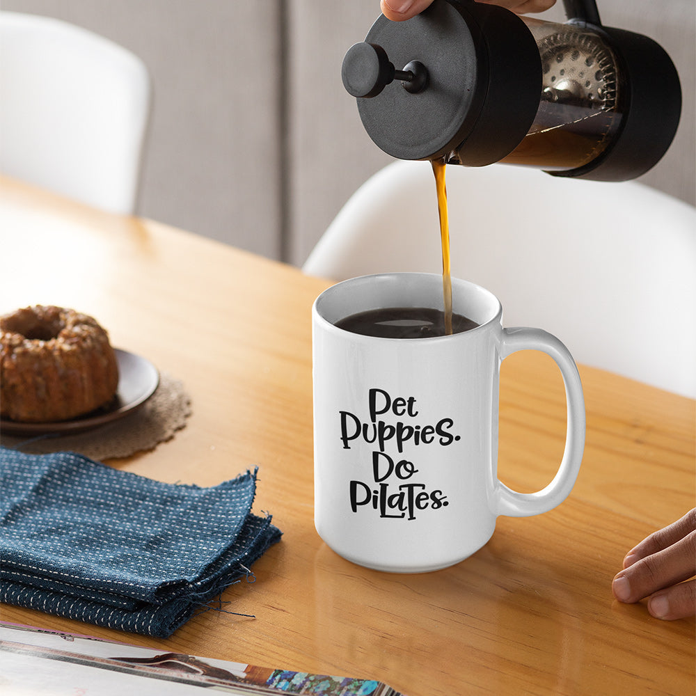 15oz white mug that has the words "Pet Puppies. Do Pilates" on the front.