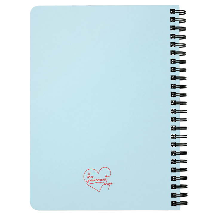 Light blue notebook with the movement shop logo on the back