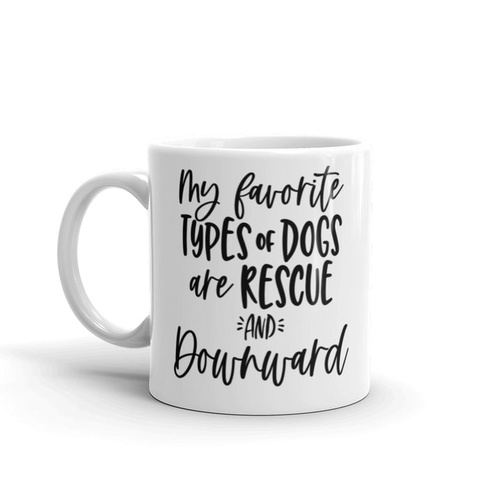 11oz white coffee mug that says "my favorite types of dogs are rescue and downward" in black text that is script and non script.