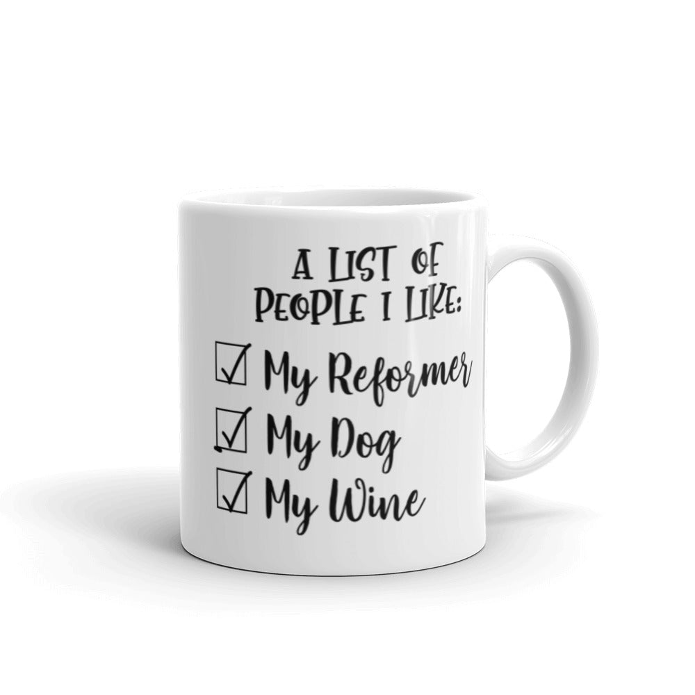 11 oz white coffee mug that says "A list of people I like: My reformer, My dog, My Wine".