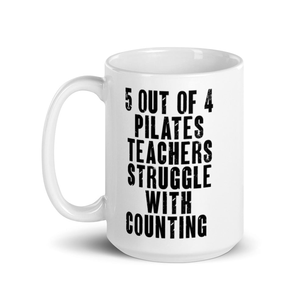 White 15 oz. Coffee Mug that says "5 out of 4 Pilates Teachers Struggle In Counting" in black text