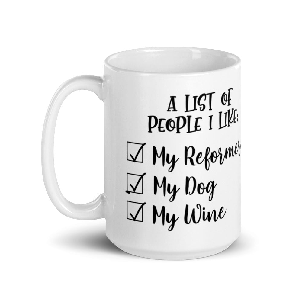 15 oz white coffee mug that says "A list of people I like: My reformer, My dog, My Wine".