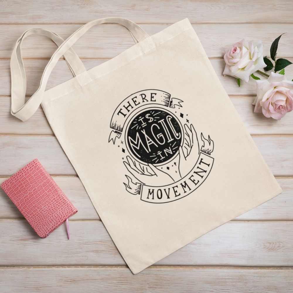 Canvas tote with handles that says "There is Magic In Movement" in black text. It is designed to look like crystal ball.