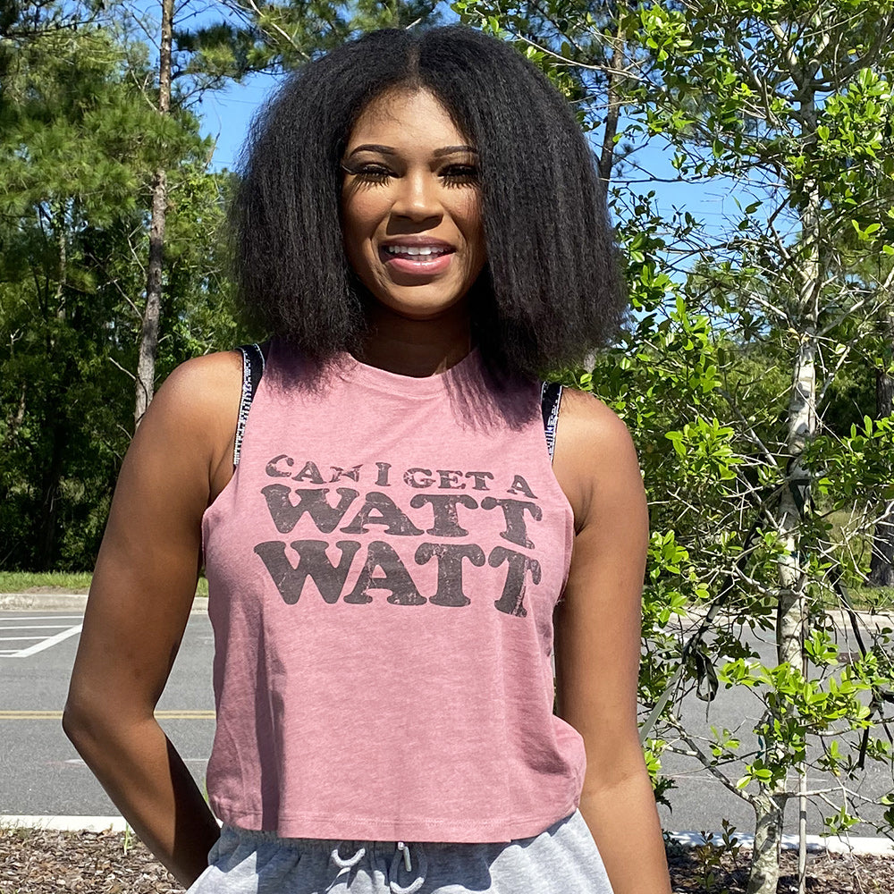 Woman wearing a heather mauve crop top that says "Can I get a watt watt?" from The Movement Shop
