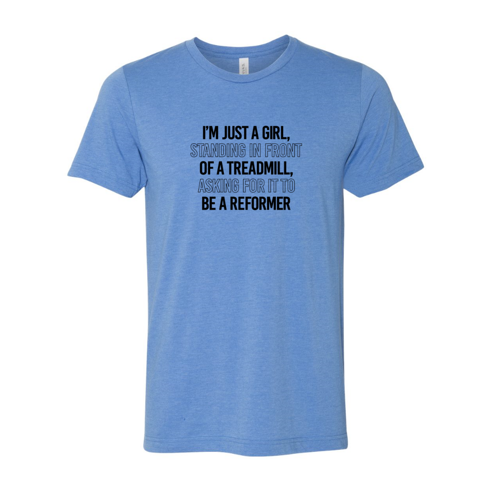 Woman wearing a heather columbia blue crewneck t-shirt that says "I'm just a girl standing in from of a treadmill, asking for it to be a reformer" 