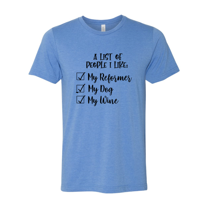 A heather columbia blue unisex crewneck t-shirt that says "A list of people I like: my reformer, my dog, my wine" in black script