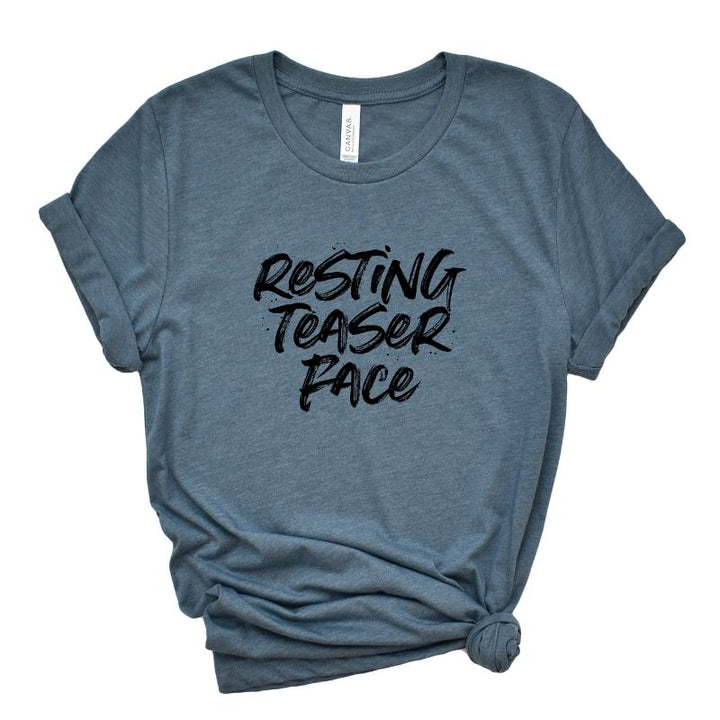 A heather slate unisex crew t-shirt that says "Resting Teaser Face" in black text