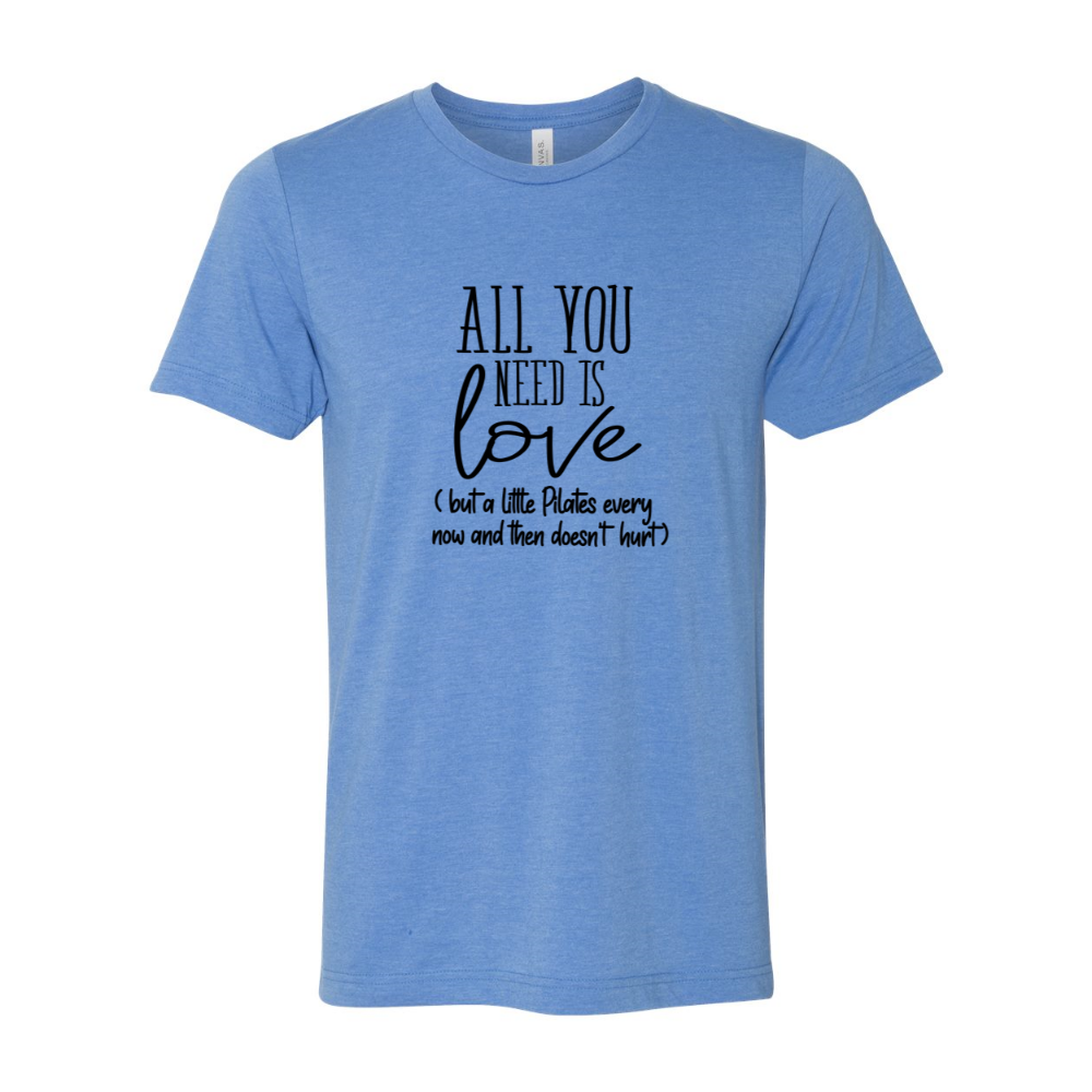 A heather columbia blue unisex crewneck t-shirt that says "all you need is love" but a little Pilates every now and then doesn't hurt"