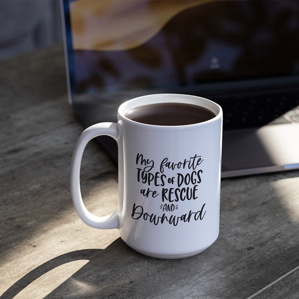 15oz white coffee mug that says "my favorite types of dogs are rescue and downward" in black text that is script and non script.
