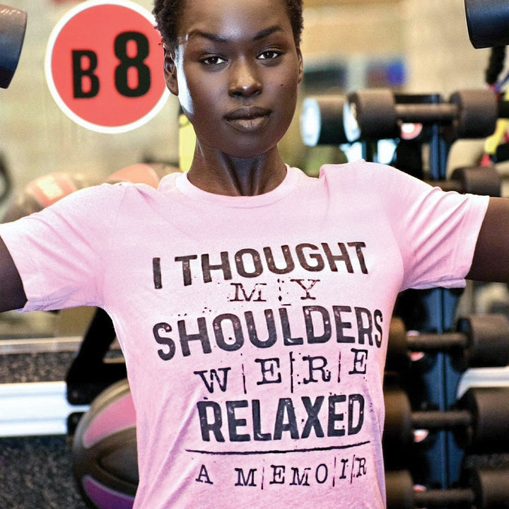 Woman wearing a heather orchid unisex crew neck t-shirt that says "I thought my shoulders were relaxed" in black text.