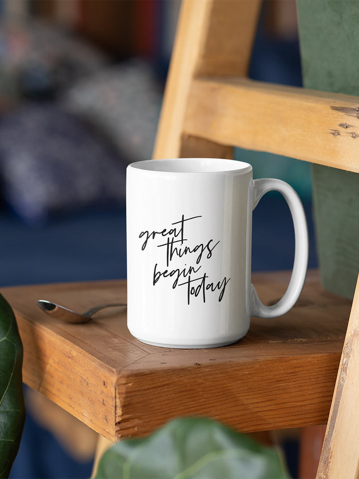 White 15 oz coffee mug that says "Great things begin today" in black text. The quote is a nod to the Joseph Pilates Quote, "every moment of our lives can be the beginning of great things"