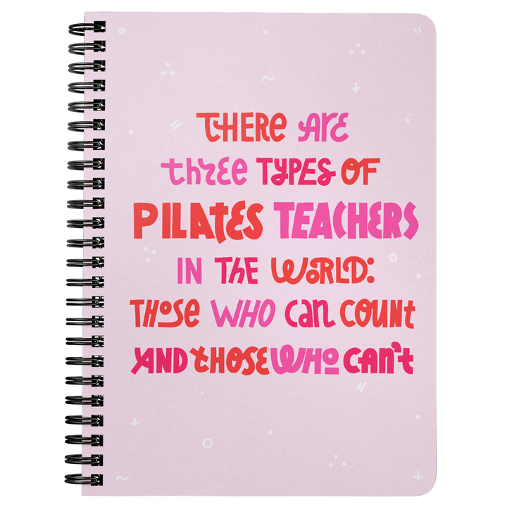 Pink spiral bound notebook that says 'there are three types of pilates teachers in the world: those who can count and those who can't 