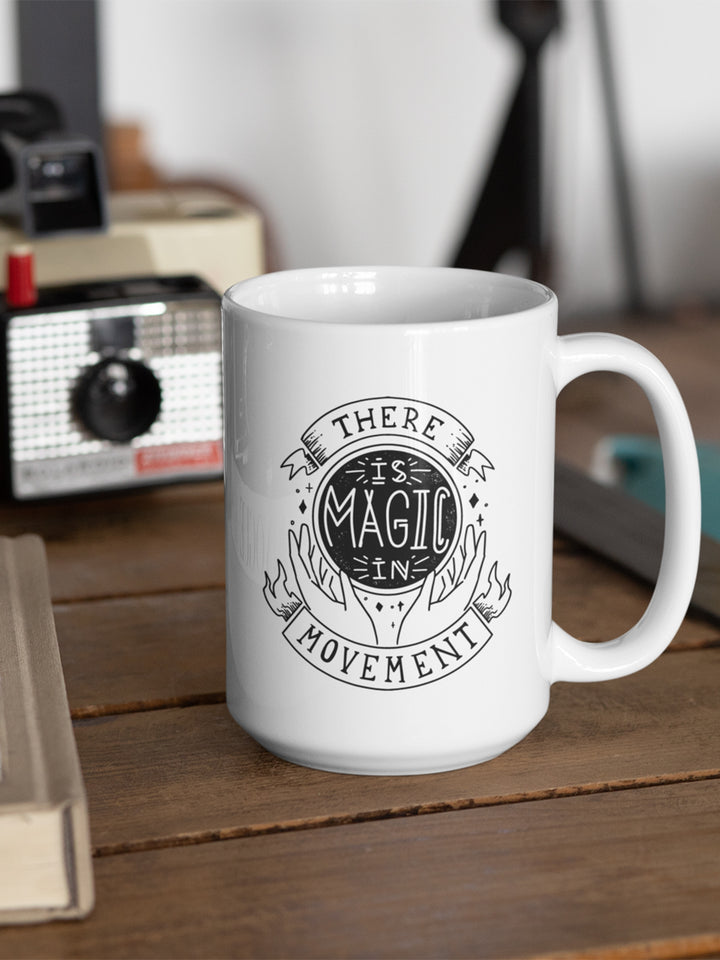 White Coffee Mug that says "There Is Magic In Movement" and designed to look like a crystal ball. 