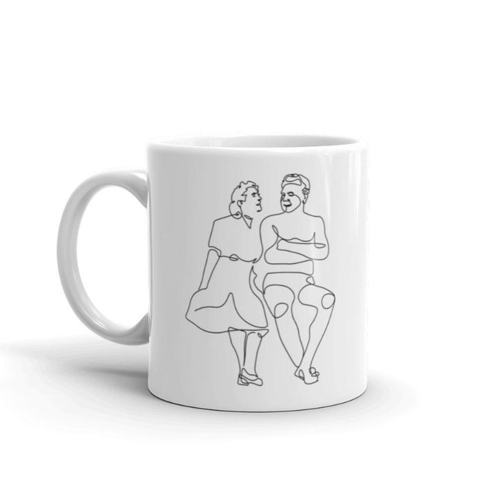 11 oz white coffee mug that with a single line drawing of Clara Pilates and Joe Pilates. Drawing is on both sides of the mug.