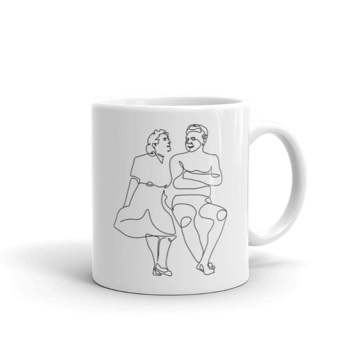 11 oz white coffee mug that with a single line drawing of Clara Pilates and Joe Pilates.