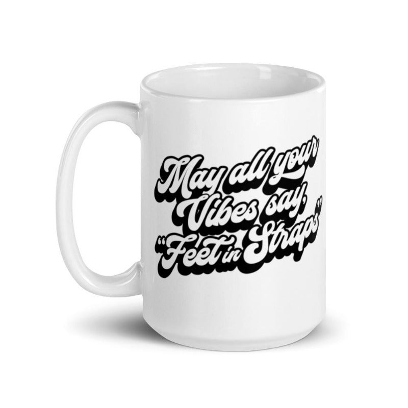 15oz white coffee mug that says "May all your vibes say Feet In Straps" in retro black font