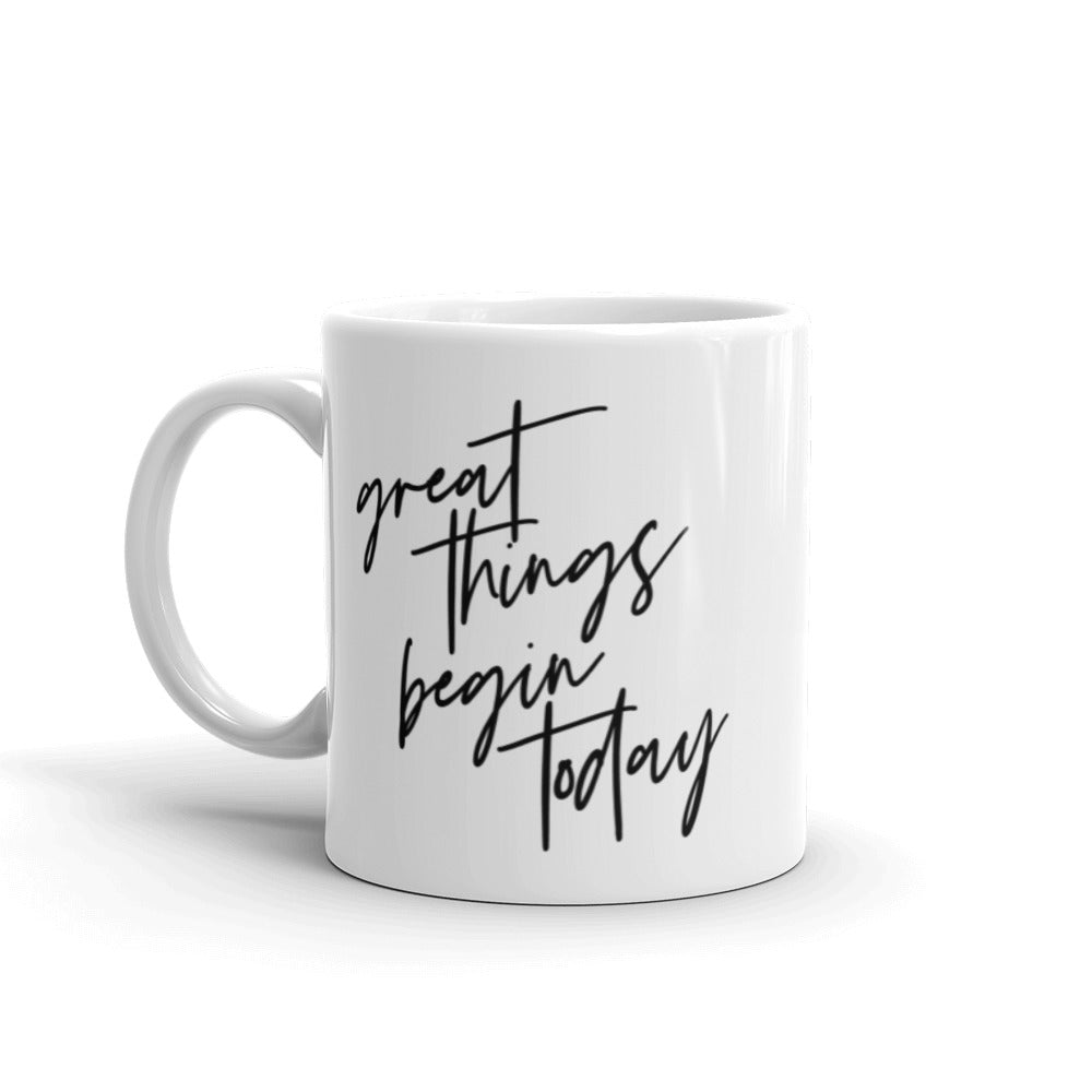 White 11 oz coffee mug that says "Great things begin today" in black text. The quote is a nod to the Joseph Pilates Quote, "every moment of our lives can be the beginning of great things"
