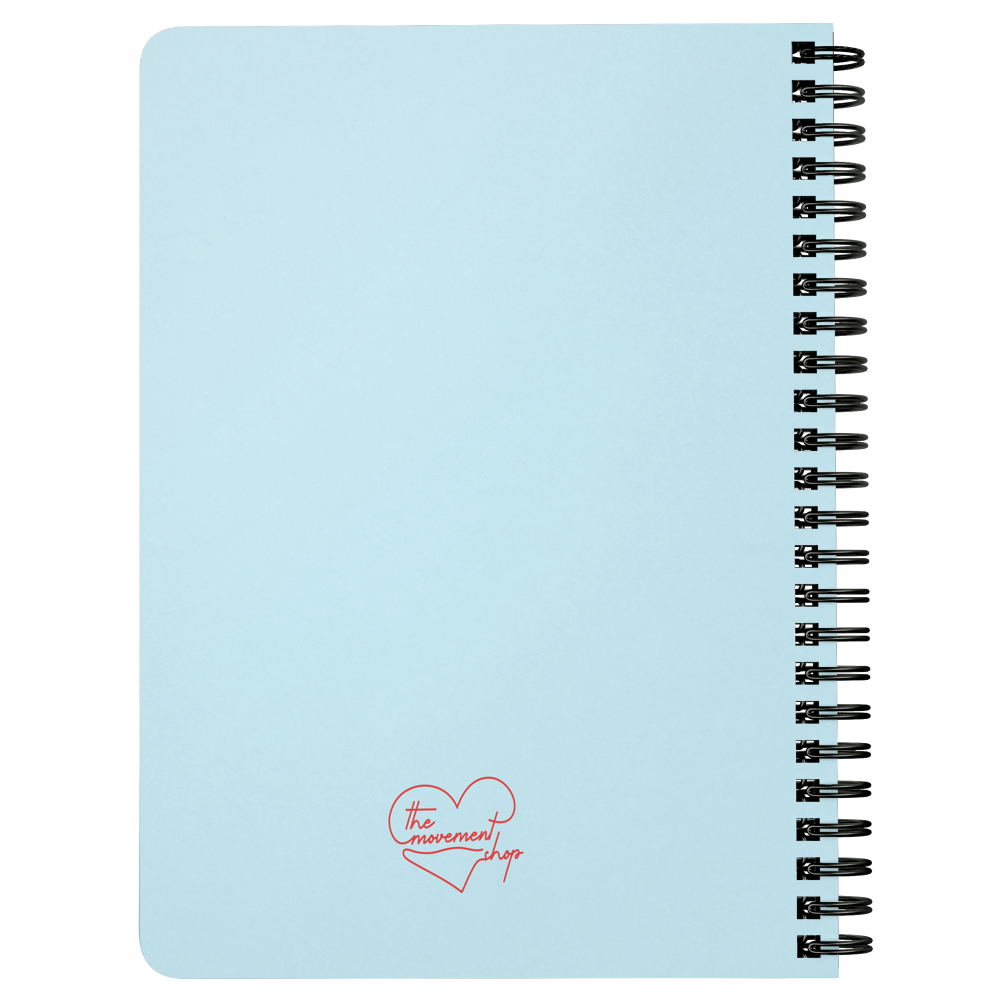 Light blue notebook with the movement shop logo on the back
