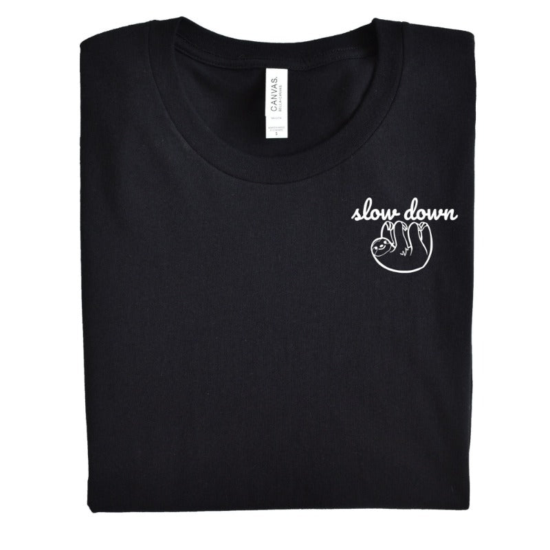 Folded Heather Black Unisex Crewneck T-Shirt that has the text "slow down" in white script over a white sloth on her left chest logo. 