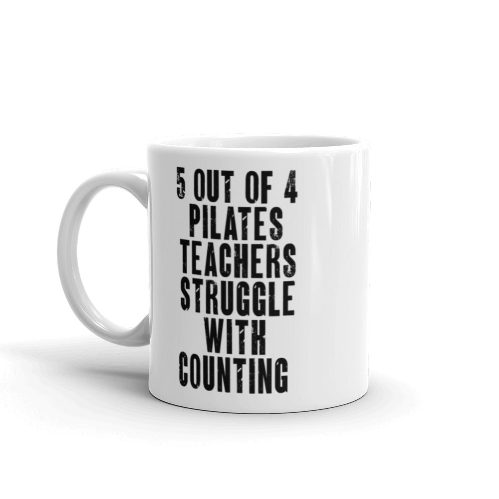 White 11 oz. Coffee Mug that says "5 out of 4 Pilates Teachers Struggle In Counting" in black text