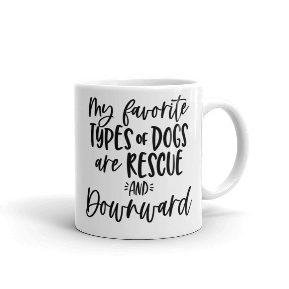 11oz white coffee mug that says "my favorite types of dogs are rescue and downward" in black text that is script and non script.