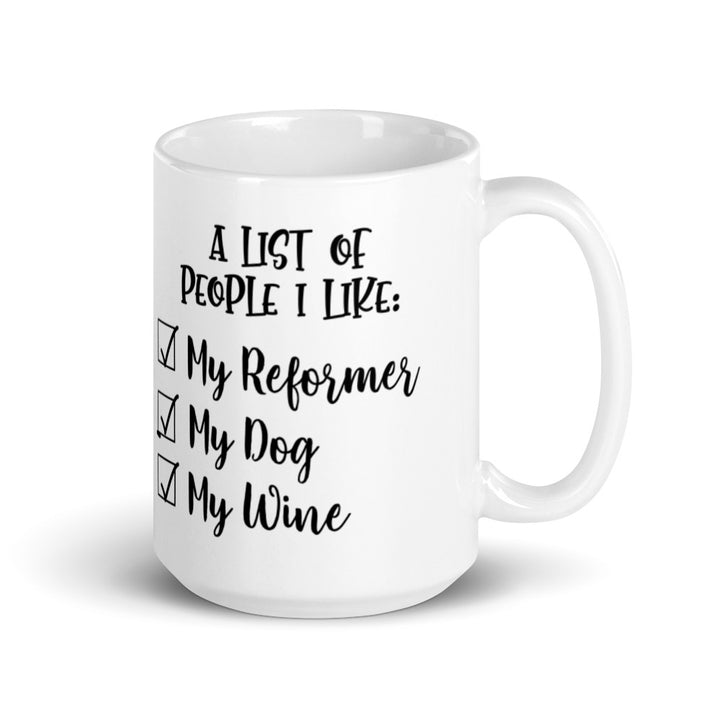 15 oz white coffee mug that says "A list of people I like: My reformer, My dog, My Wine".
